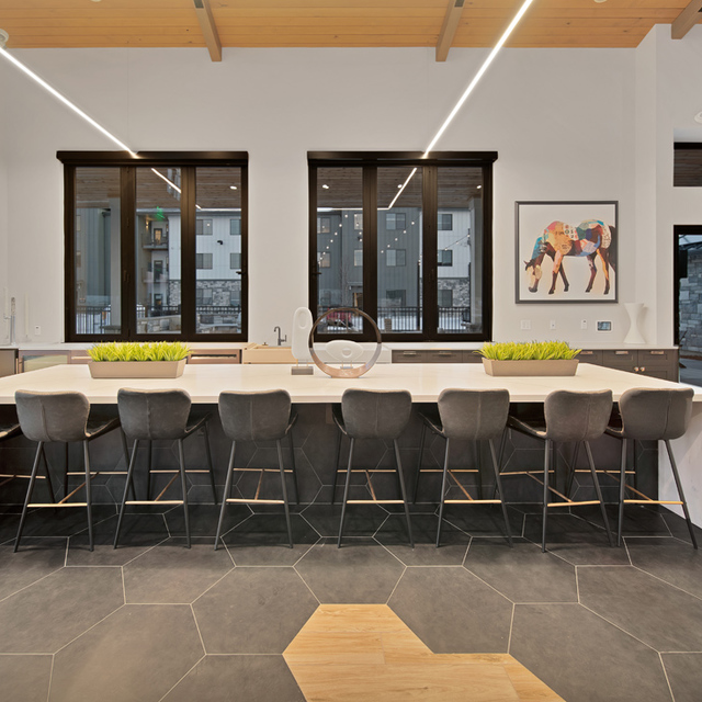 Camber Apartments - Resident Clubhouse Dining Area with Long Table and Chairs